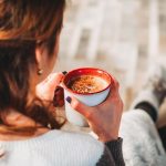 woman relaxing at home with cup of coffee